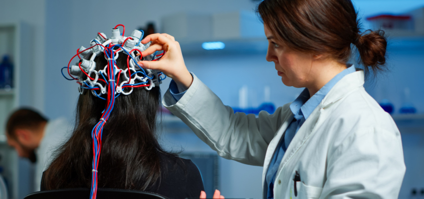 Doctor adjusting equipment to study patient brain activity