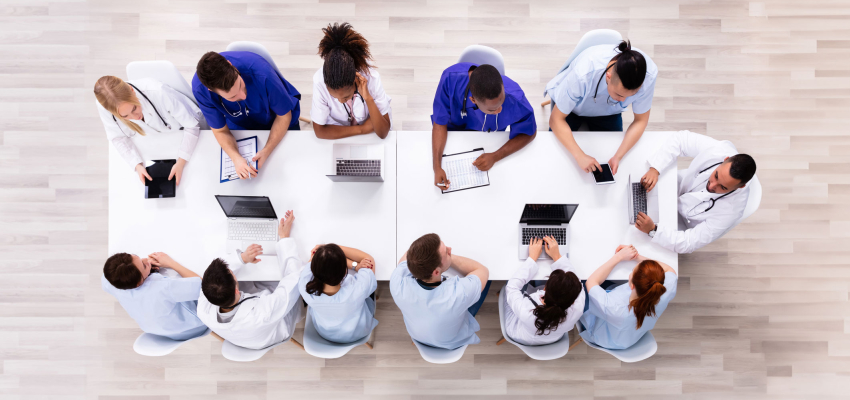 An over head photo of staff doctors meeting at a table