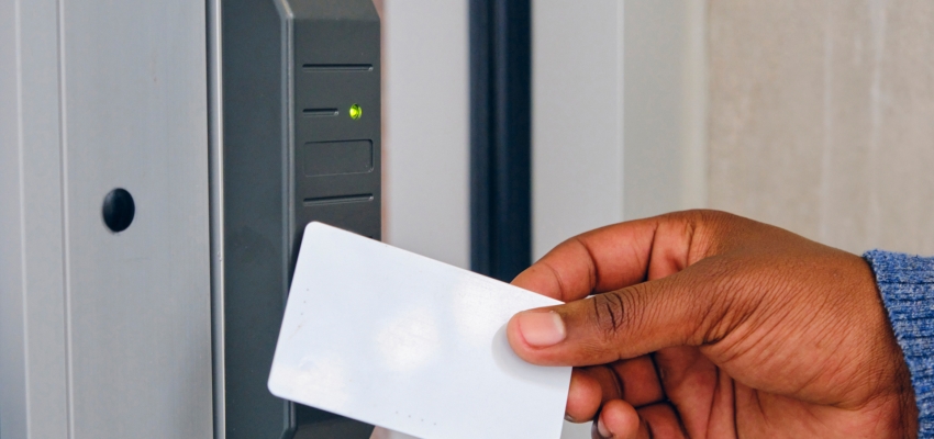 a photo of hand holding a key/access card