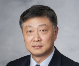 A professional headshot of Ming Jin, MD, in business attire