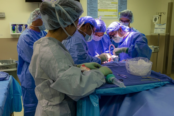 A group of neurosurgeons perform surgery on a patient