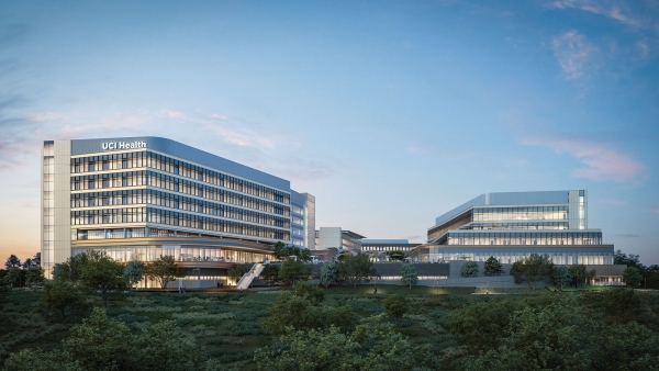 UC Irvine Medical Center — Irvine Facility — Modern healthcare facility with glass windows and labeled “UCI Health” against an evening sky.