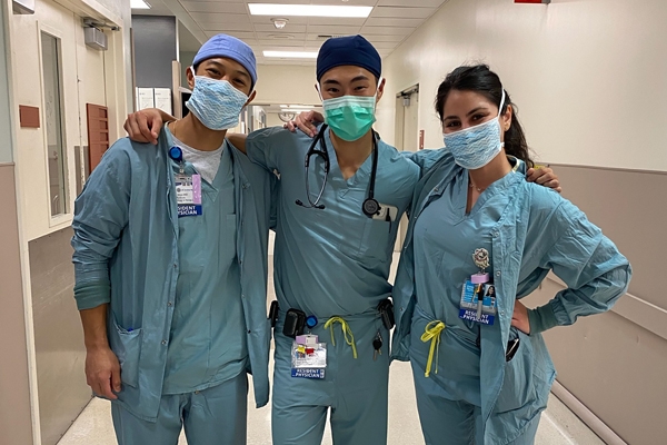 A group of three Anesthesiology residents working in the hospital pose for a photo