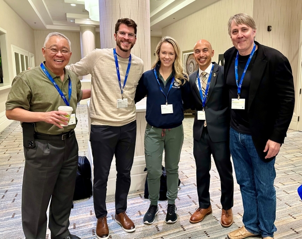 A group of residents with their faculty mentors at a research conference