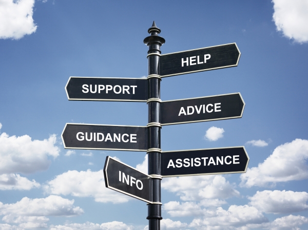 Help, support, advice, guidance, assistance and info crossroad signpost against blue sky.