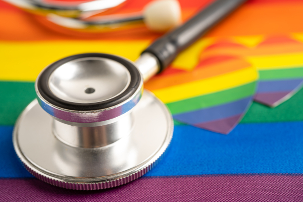 Black stethoscope on rainbow flag with heart, symbol of LGBT pride month celebrate annual in June social, symbol of gay, lesbian, bisexual, transgender, human rights and peace.