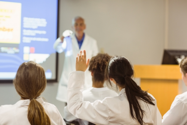 a photo of a professor giving lecture to class of medical students