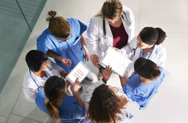 High angle shot of a group of medical practitioners analyzing data in a hospita