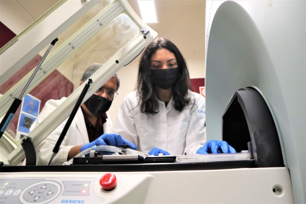 MicroPET/CT/SPECT Research Imaging Lab — From Left to right: Dr. Jogesh Mukherjee in discussion with trainee, Reisha Ladwa, on how to operate the MicroPET/CT system.