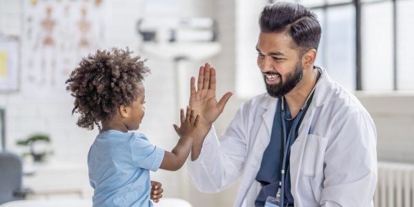 Pediatrician high-fiving patient