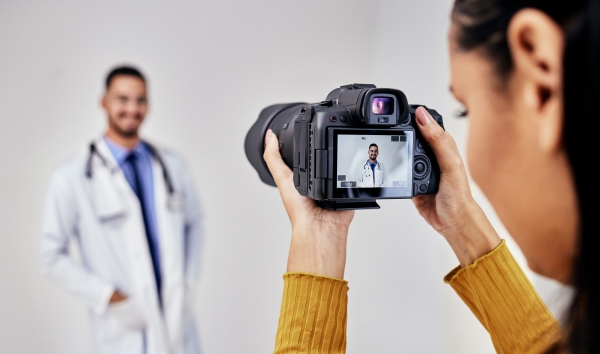 a photographer taking a picture of a doctor