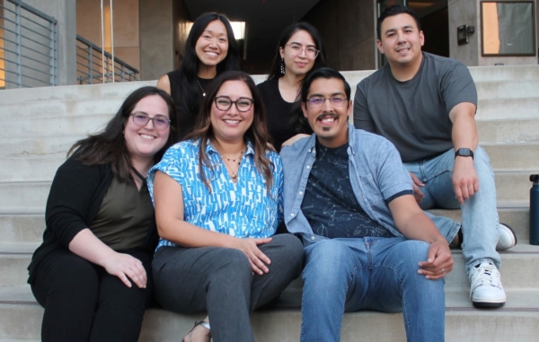 Prime Residency Track — 2025, A group of six people sits on outdoor steps, smiling at the camera.