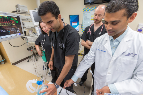 Resident working with medical students