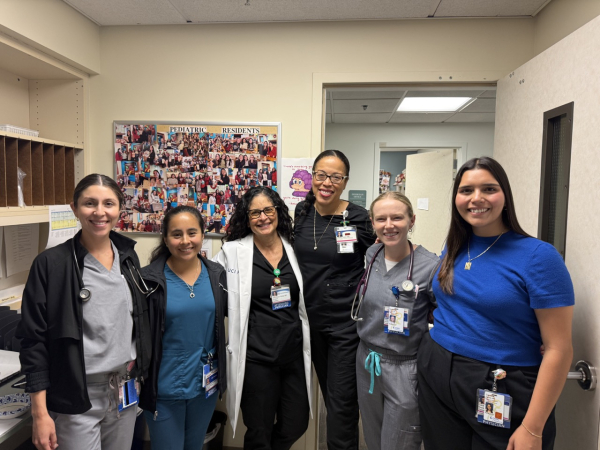 A group of pediatrics residents and faculty members pose for a photo during a clinical rotation