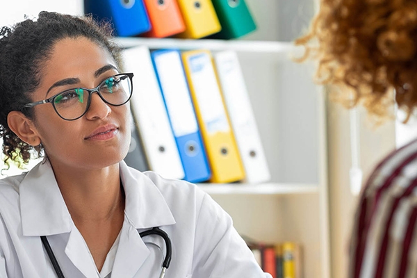 A doctor meeting with a patient in their office