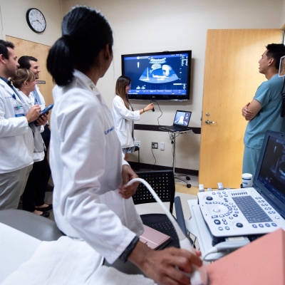 A group of medical students are being trained on ultrasound imaging