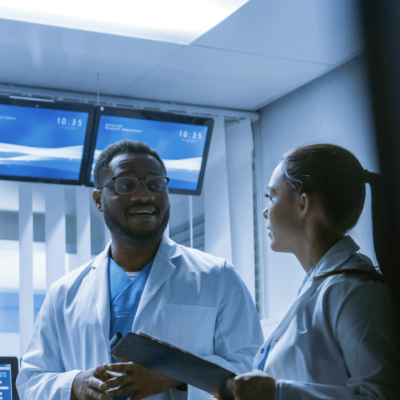 Meeting of the Team of Medical Scientists in a Research Laboratory. Doctors Having Analytical Discussion Surrounded by Monitors 