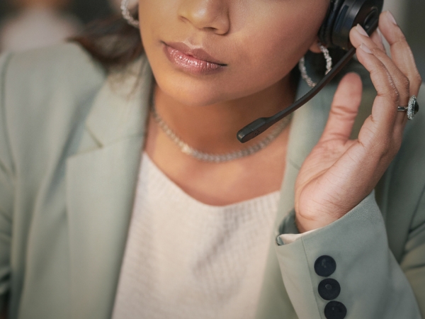 Shot of a woman using a headset and listening 