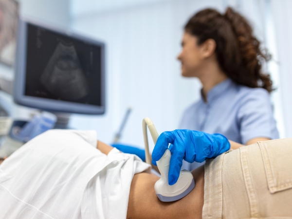 Doctor conducts ultrasound examination of patient kidney