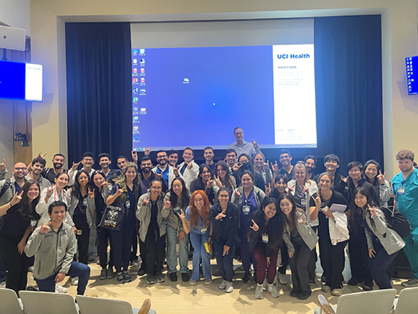 A group of medical students gather around in a lecture hall