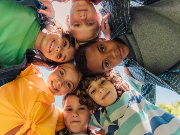 Center on Stress & Health stock photo of children and teens standing together looking down at the camera