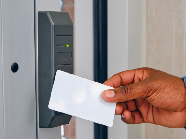 a photo of hand holding a key/access card