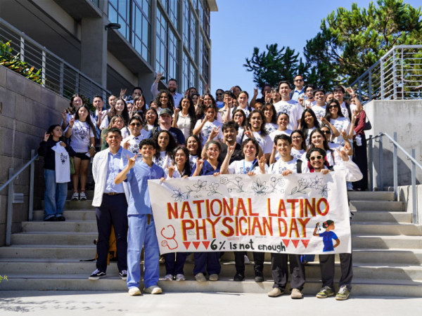 A group of students stand behind a banner that says "National Latino Physician Day: 6% is not enough."