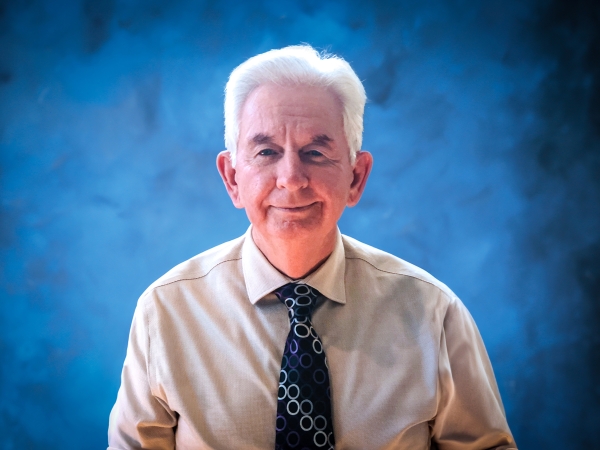 Cameron Carter, headshot with blue background