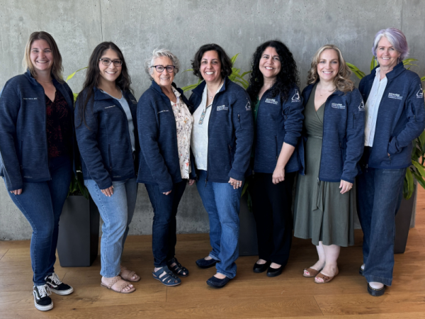 Seven women standing together, all wearing jackets with the logo “UC Irvine Institute for Clinical and Translational Science.”