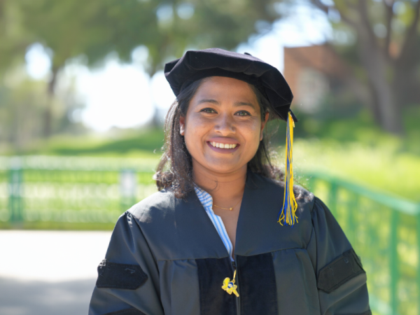 Mahina Mitul in a cap and gown