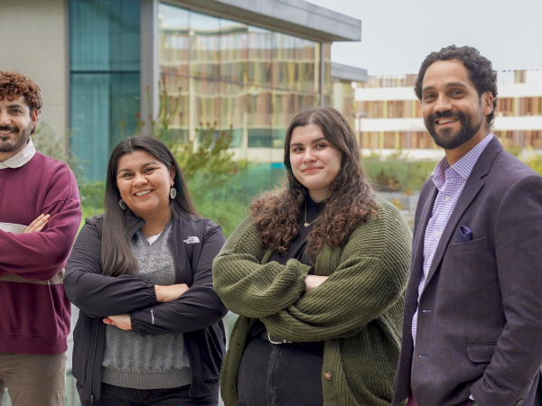 Three graduate students standing next to Gerard Slobogean