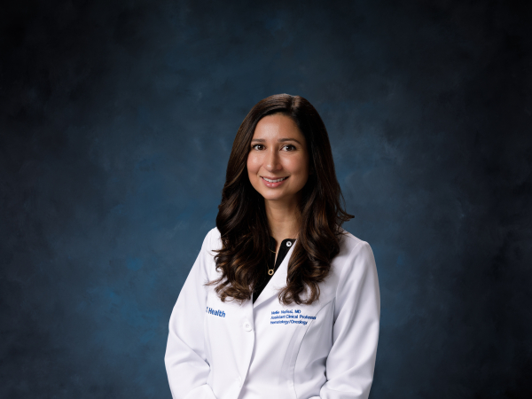 Headshot of Nellie Nafissi in whitecoat
