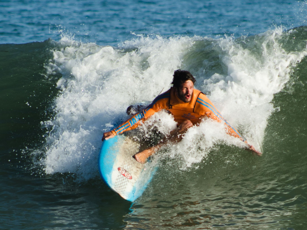 Surfer riding a powerful wave with skill and focus at sea.