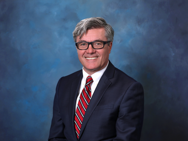 Headshot of Adrian Preda in suit. 