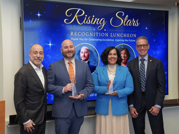 Gibney and Glover hold their awards as they stand with Lefteris and Stamos. Behind them is a presentation slide that reads: Rising Stars recognition luncheon. Thank you for celebrating excellence. Inspiring the future. 