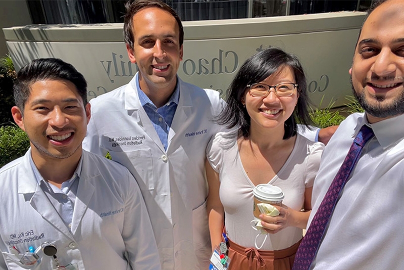Close-up of four people outside the Chao Cancer Center