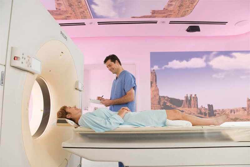 Medical practitioner with patient preparing for CT scan 