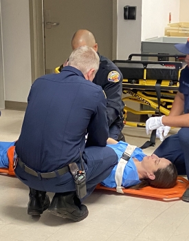 Four first responders working together with mock patient 