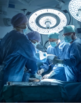 Doctors wearing blue scrubs in the operating room