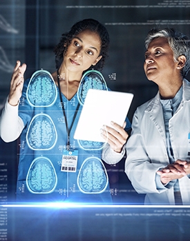 Two doctors discuss a patient's brain scans