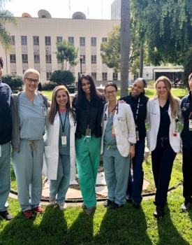 Family medicine residents in scrubs pictured outside of the hospital