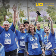 Six runners wearing UCI t-shirts smiling at the finish line