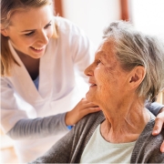 Nurse comforting elderly person