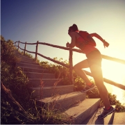 woman in work out clothes running up stairs