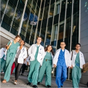 UC Health Group of Doctors in green scrubs and whitecoats