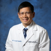 Headshot of Wengui Yu in white coat. 