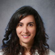 Nadine Abi-Jaoudeh headshot with gray background