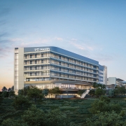 UC Irvine Medical Center — Irvine Facility — Modern healthcare facility with glass windows and labeled “UCI Health” against an evening sky.