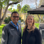 Rimal Bera and Mindy Andrews stand with buildings and trees in the background