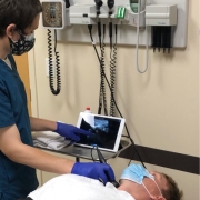 UCI medical student using the Butterfly portable ultrasound machine.